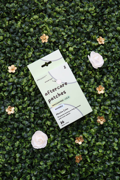 Pack of aftercare patches on a green textured surface with flowers