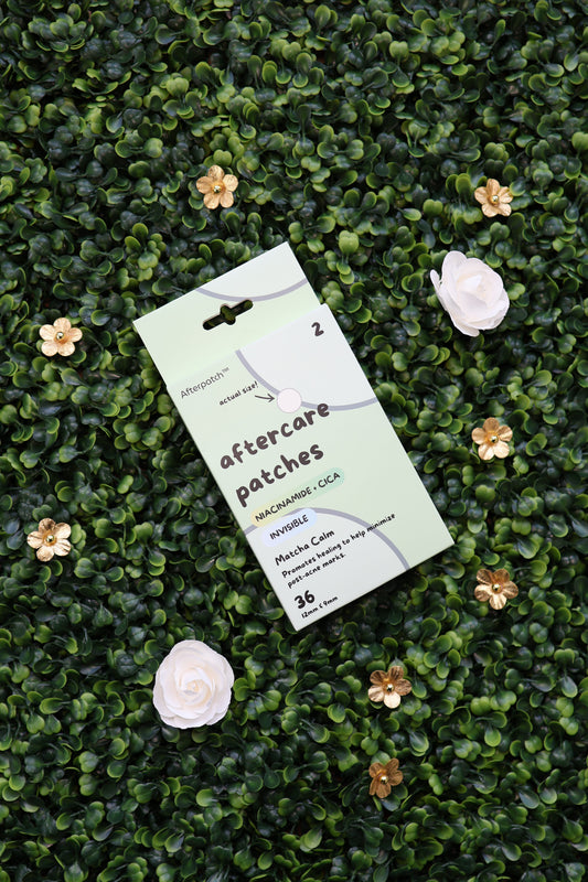 Pack of aftercare patches on a green textured surface with flowers